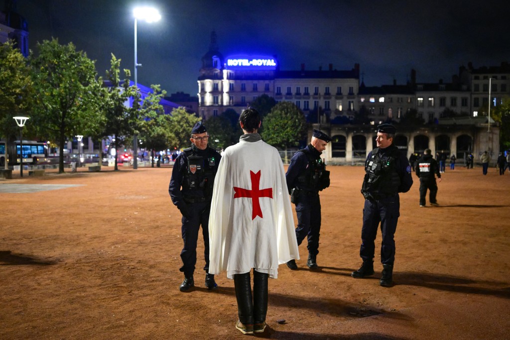 Photo by OLIVIER CHASSIGNOLE / AFP  French police officers check a person during a partial curfew in Lyon on October 19, 2026, following weekend demonstrations over soaring prices degenerated into some of the worst street violence in recent years.