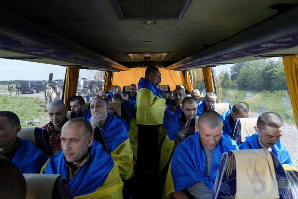 Ukrainian soldiers sit in a bus in the Sumy region of Ukraine after returning from captivity in Russia, May 31, 2024. (AP Photo/Evgeniy Maloletka, File)