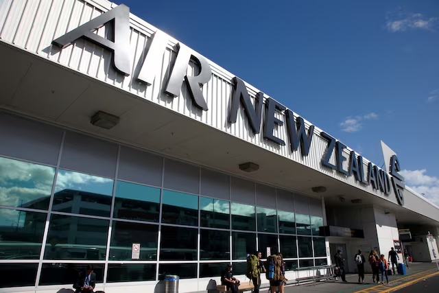 Travellers walk under an Air New Zealand sign at Auckland Airport in New Zealand, September 20, 2017. REUTERS/Nigel Marple