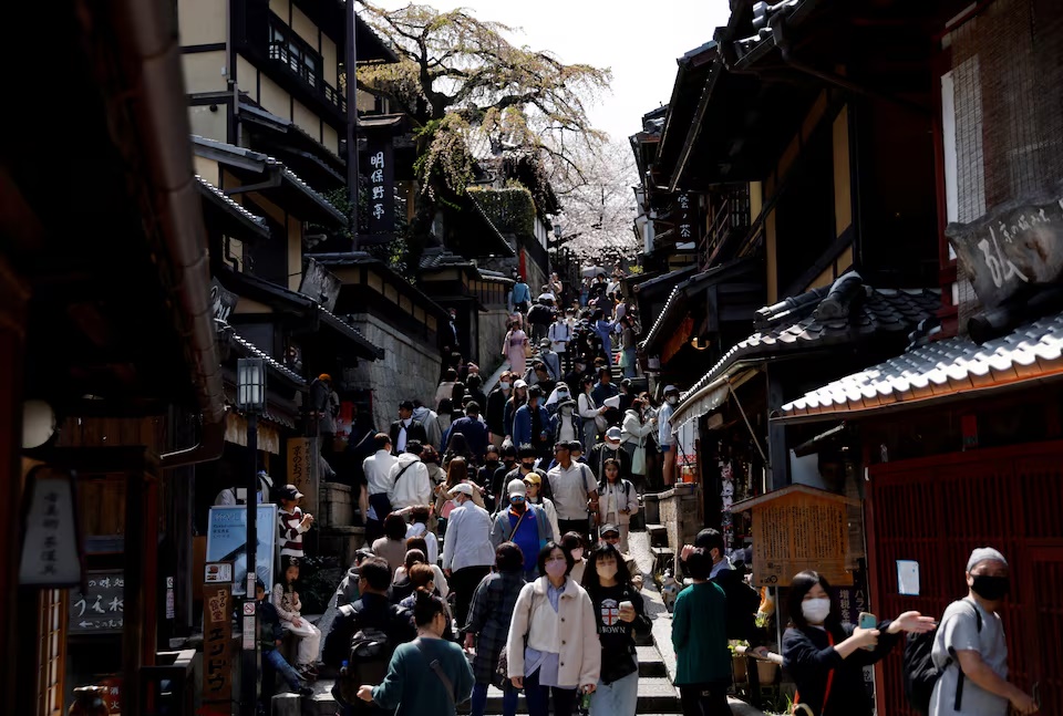A crowd of tourists walk on the street near Kiyomizu-dera temple in Kyoto, western Japan March 30, 2023. REUTERS/Issei Kato/File Photo A crowd of tourists walk on the street near Kiyomizu-dera temple in Kyoto, western Japan March 30, 2023. REUTERS/Issei Kato/File Photo