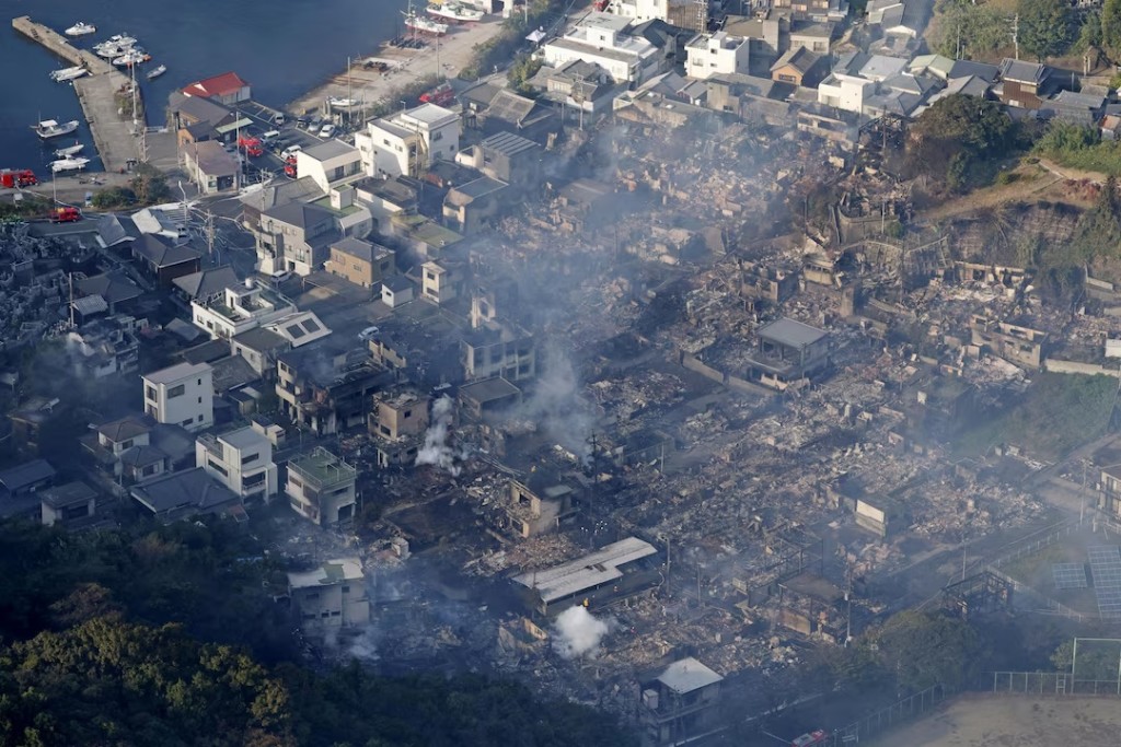  Smoke rises from a site where a massive fire blazed through more than 170 buildings, as seen from a helicopter, in Oita, Oita Prefecture, southwestern Japan, November 19, 2025, in this photo taken by Kyodo. Mandatory credit Kyodo/via REUTERS 