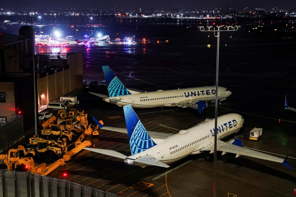 Grounded aircraft operated by United Airlines, as a damaged Air Canada Express jet and a ground vehicle that collided are seen in the background at La Guardia Airport in Queens, New York, U.S. March 23, 2026. (Reuters)