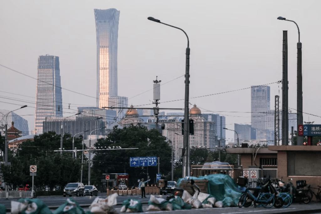 A police officer directs traffic in the street, with Beijing Central Business District skyline seen in the background, ahead of this week’s U.S. President Donald Trump's visit to China, in Beijing, China, May 11, 2026. REUTERS/Maxim Shemetov