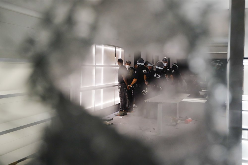 New York police officers arrest a person inside a Balenciaga store early Tuesday, June 2, 2020, in New York.