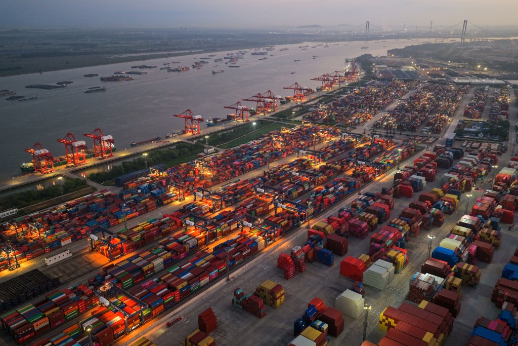 Cargo ships and containers are seen at the container terminal of Nanjing Port, in China’s eastern Jiangsu province early on September 8, 2026. (Photo by CN-STR / AFP) / CHINA OUT