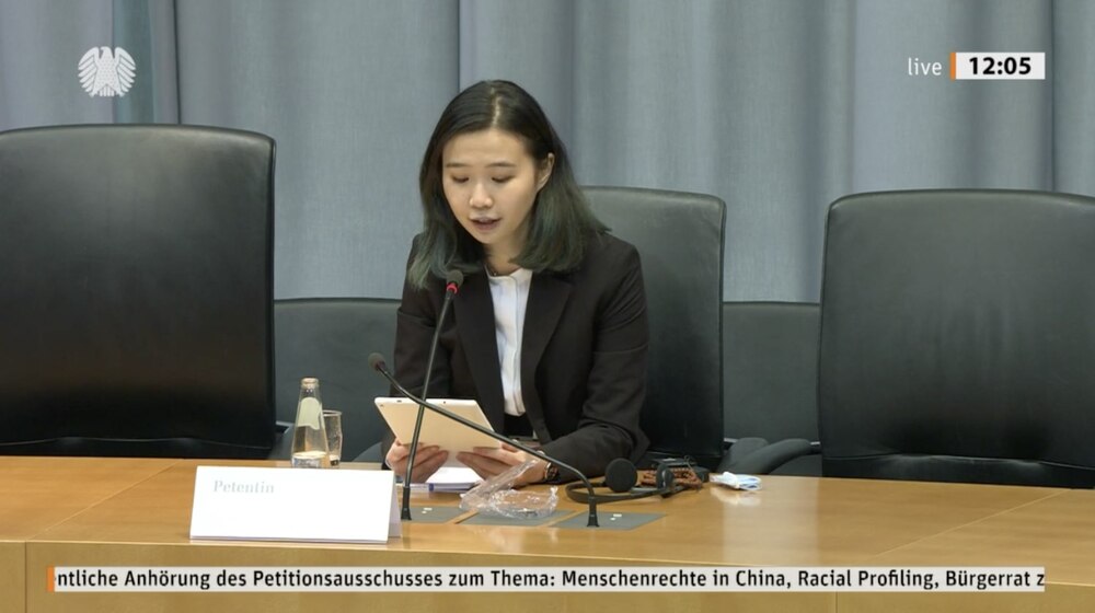 Glacier Kwong and Petra Sigmund speak at a German parliamentary meeting. Glacier Kwong and Petra Sigmund speak at a German parliamentary meeting.