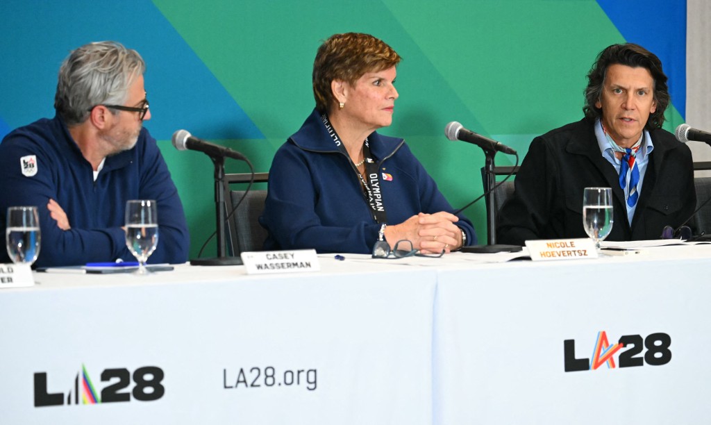 LA28 and International Olympic Committee officials Casey Wasserman, Nicole Hoevertsz and Christophe Dubi attend a LA28 and International Olympic Committee news conference on preparations for the 2028 Games at the JW Marriott L.A. Live in Los Angeles on June 4, 2026. (Photo by Patrick T. Fallon / AFP)