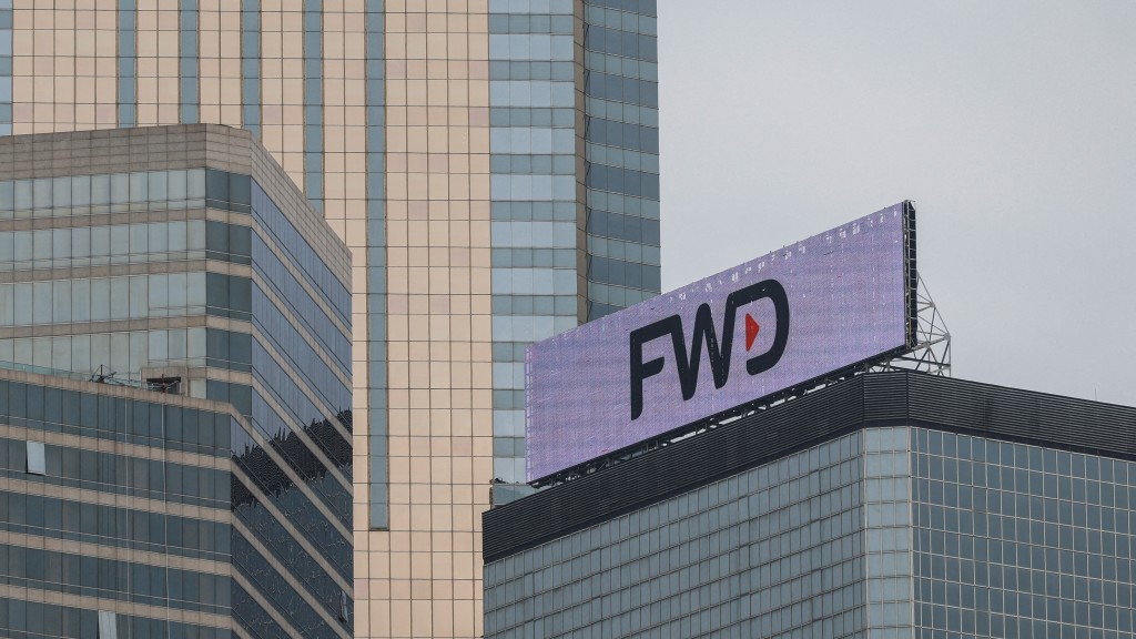 The logo of FWD group is seen on a building in Hong Kong, China March 20, 2023. REUTERS/Tyrone Siu/File Photo