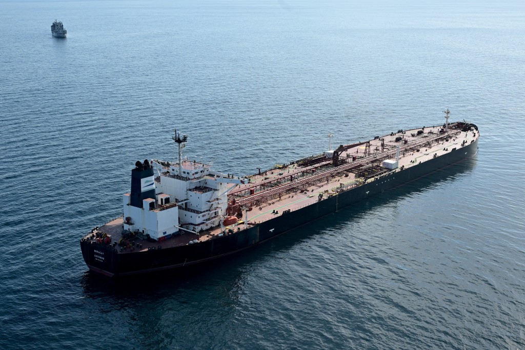 This aerial picture taken on October 1, 2025 off the coast of the western France port of Saint-Nazaire shows the tanker Boracay from Russia's so-called "shadow fleet" suspected of being involved in drone flights over Denmark which sailed off the Danish coast between September 22 and 25, with a boat of the French Navy in the background.  (Photo by Damien MEYER / AFP)