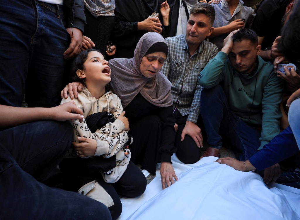 Mourners attend the funeral of Palestinians killed in an Israeli strike in Gaza City on October 20. (REUTERS)