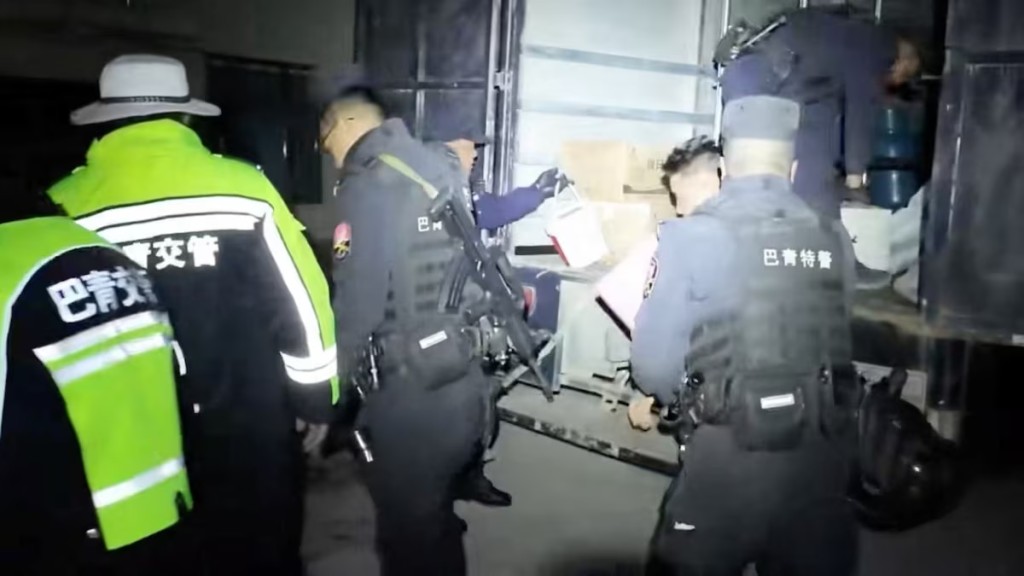 Emergency services personnel place items retrieved from a building into a vehicle, following an earthquake, at a location given as Nagqu, Tibet Autonomous Region, China in this still image from video released October 23, 2026. Nagqu Police Department/Handout via REUTERS