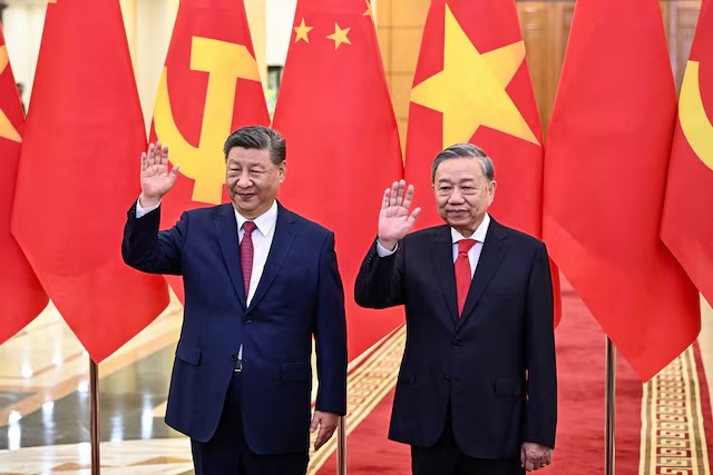 Vietnam's Communist Party General Secretary To Lam and China's President Xi Jinping wave during a meeting at the office of the Party Central Committee in Hanoi on April 14, 2025. NHAC NGUYEN/Pool via REUTERS/File Photo