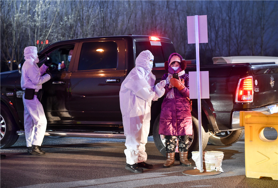 A passing vehicle is checked at an expressway check point in the high coronavirus risk Gaocheng district of Shijiazhuang, the capital of Hebei province on the night of January 5, 2021. A passing vehicle is checked at an expressway check point in the high coronavirus risk Gaocheng district of Shijiazhuang, the capital of Hebei province on the night of January 5, 2021.