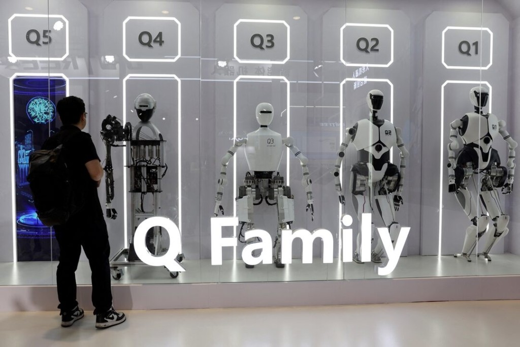 A visitor looks at humanoid robots displayed at the Institute of Automation, Chinese Academy of Sciences booth during the World Robot Conference in Beijing, China August 21, 2024. REUTERS/Florence Lo