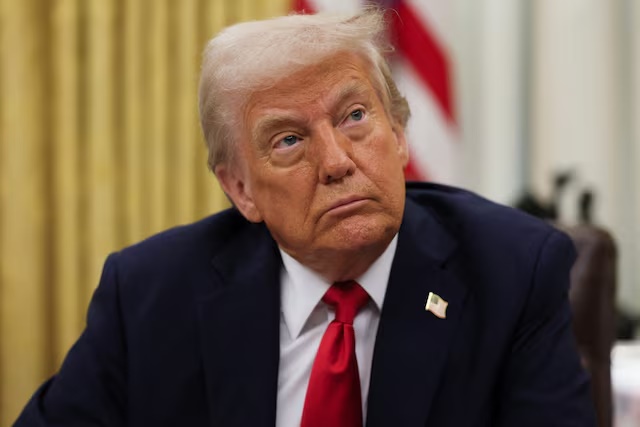 U.S. President Donald Trump prepates to sign an executive order related to the U.S. live entertainment ticketing industry in the Oval Office at the White House in Washington, D.C., March 31, 2025. REUTERS/Leah Millis/File Photo