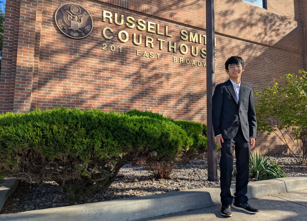 19-year-old Joseph Lee, one of the youth plaintiffs in the Lighthiser v. Trump case, poses outside Russell Smith Courthouse in Missoula, Montana, on September 17, 2025.  (Photo by Issam AHMED / AFP)