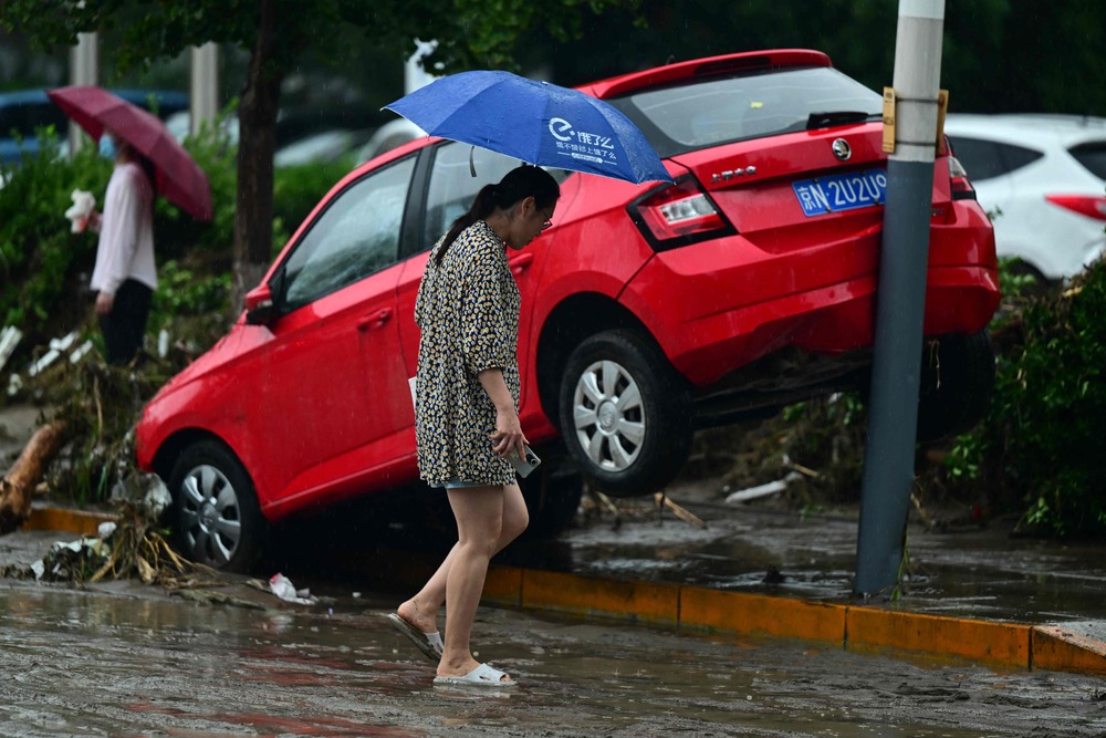 Storm Doksuri wreaks havoc in Mentougou district, washing away cars and destroying roads. AFP