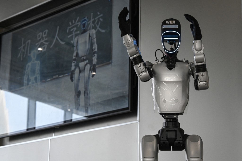 Photo by JADE GAO / AFP  The photo taken on August 4, 2026 shows a robot named Wuji, which manufactured by Unitree, giving a guided tour to visitors at the Hangzhou Robot school in Hangzhou, in eastern China's Zhejiang province.