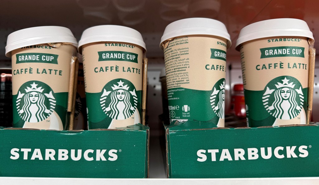 Cups of pre-made Starbucks iced latte drinks are lined up for sale on the shelf of a supermarket in Manchester, Britain, November 25, 2025. REUTERS/Phil Noble