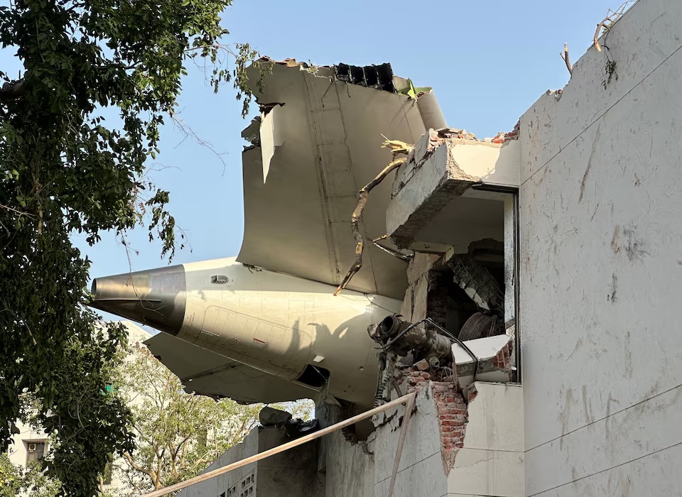 A tail of an Air India Boeing 787 Dreamliner plane that crashed is seen stuck on a building after the incident in Ahmedabad, India, June 12, 2025. REUTERS/Amit Dave/File Photo