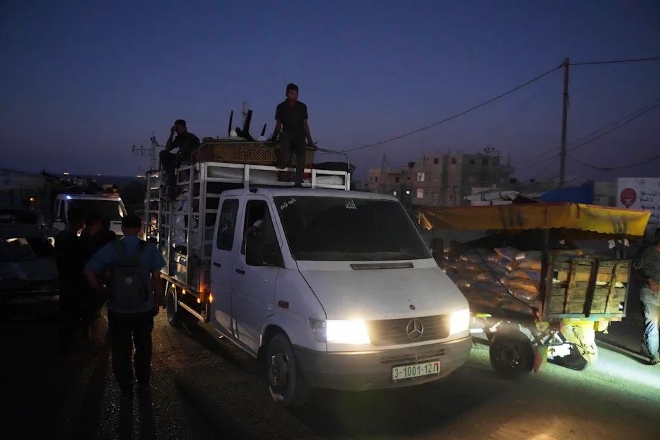 A truck transports the Abu Jarad family through Nuseirat, Gaza Strip, Sept. 10, 2025, after they were displaced from Gaza City following evacuation orders issued by the Israeli army. (AP Photo/Abdel Kareem Hana)