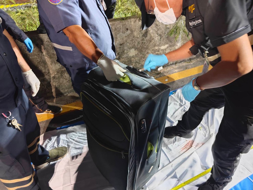Police officers inspect a suitcase after the suspected murder of a 17-year-old Thai girl, following the arrest of Australian man Simon Peter Carman at Suvarnabhumi International Airport in Bangkok. (AFP)