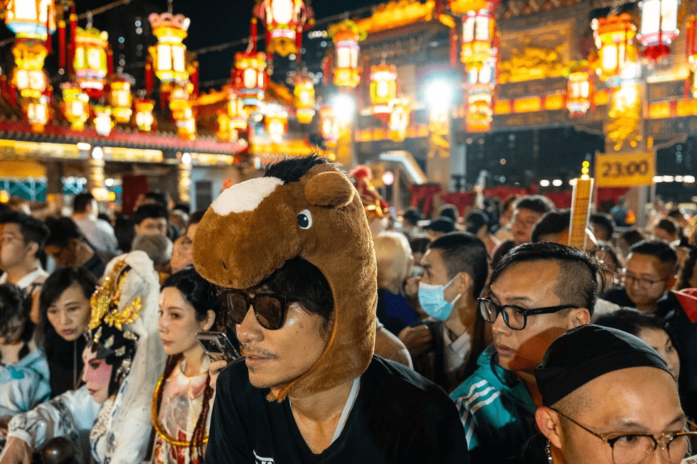 A worshiper wears a horse head decoration at Wong Tai Sin Temple to welcome the Lunar New Year of the Horse in Hong Kong, Monday, Feb. 16, 2026. (AP Photo/Chan Long Hei)