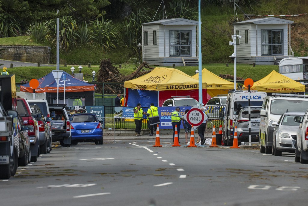 Photo by DJ MILLS / AFP  Emergency workers close a road following a landslide while a search is underway by local emergency services for missing people at Mount Maunganui in Tauranga on January 22, 2026.