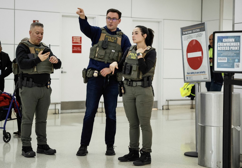 Photo by KENA BETANCUR / AFP  Federal law enforcement agents stand inside Newark Liberty International Airport in Newark, New Jersey, on March 23, 2026.