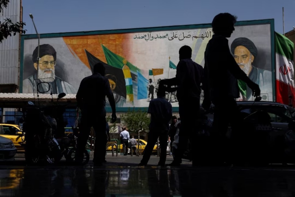 People walk past a mural depicting the late leader of the Islamic Revolution, Ayatollah Ruhollah Khomeini, and the late Iran's Supreme Leader Ayatollah Ali Khamenei, in Tehran, Iran, May 12, 2026. Majid Asgaripour/WANA (West Asia News Agency) via REUTERS