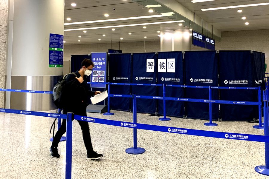 A passenger walks into the waiting area for temperature check and information registration at the Shanghai Pudong International Airport in Shanghai, March 15. A passenger walks into the waiting area for temperature check and information registration at the Shanghai Pudong International Airport in Shanghai, March 15.