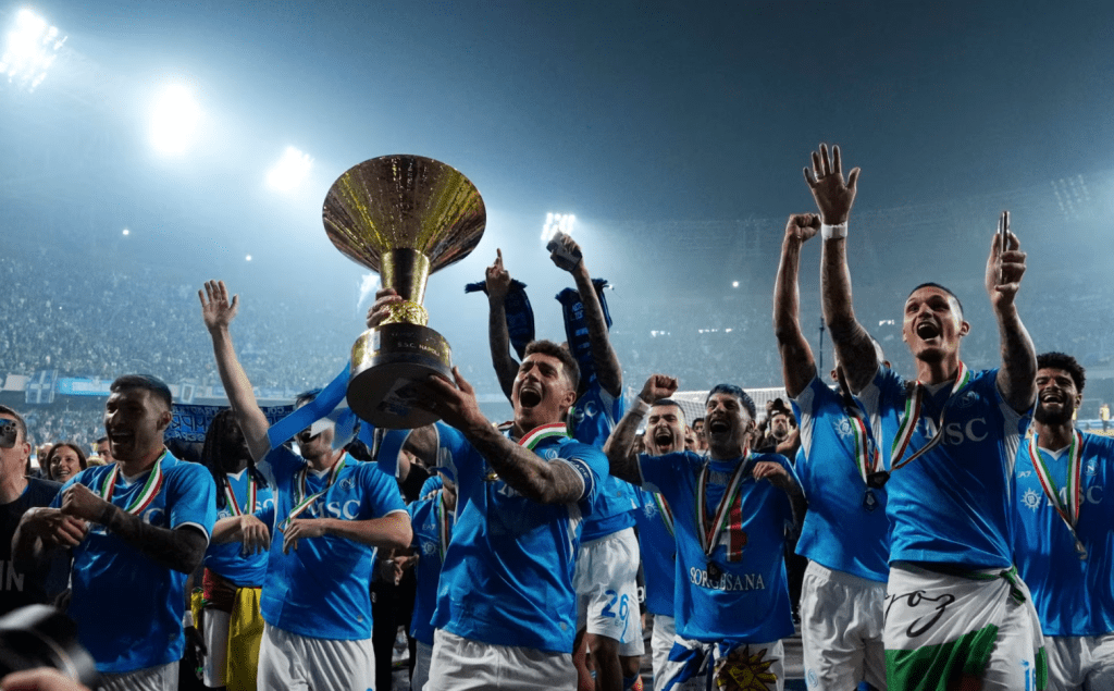 Giovanni Di Lorenzo celebrates with the trophy and teammates after winning Serie A. (REUTERS/Matteo Ciambelli)