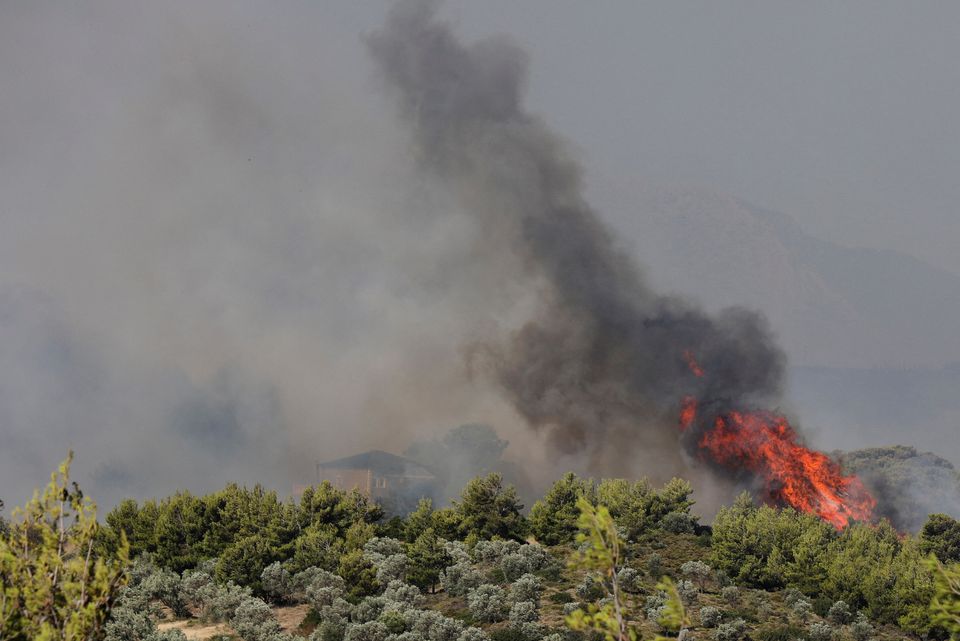 A house is engulfed in smoke as a wildfire burns nearby in the Pikermi suburb of Athens, Greece. (Reuters) A house is engulfed in smoke as a wildfire burns nearby in the Pikermi suburb of Athens, Greece. (Reuters)