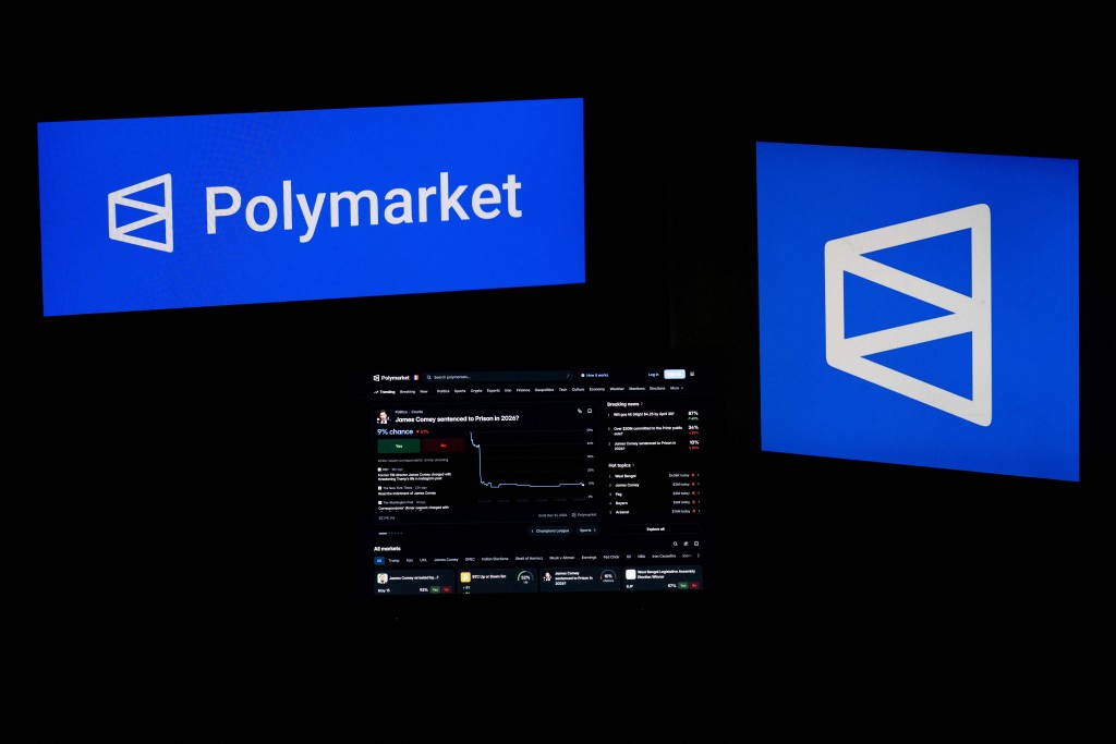 This photograph shows set up screens displaying the logo and home page of US cryptocurrency based prediction market platform Polymarket, in Saint-Mande, east of Paris, on April 29, 2026. AFP