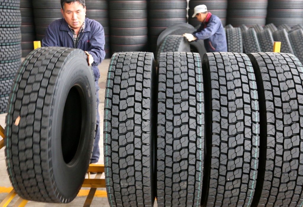 Employees move newly made tyres at a factory in Nantong, Jiangsu province, China April 28, 2019. Picture taken April 28, 2019.  REUTERS/Stringer ATTENTION EDITORS - THIS IMAGE WAS PROVIDED BY A THIRD PARTY. CHINA OUT.