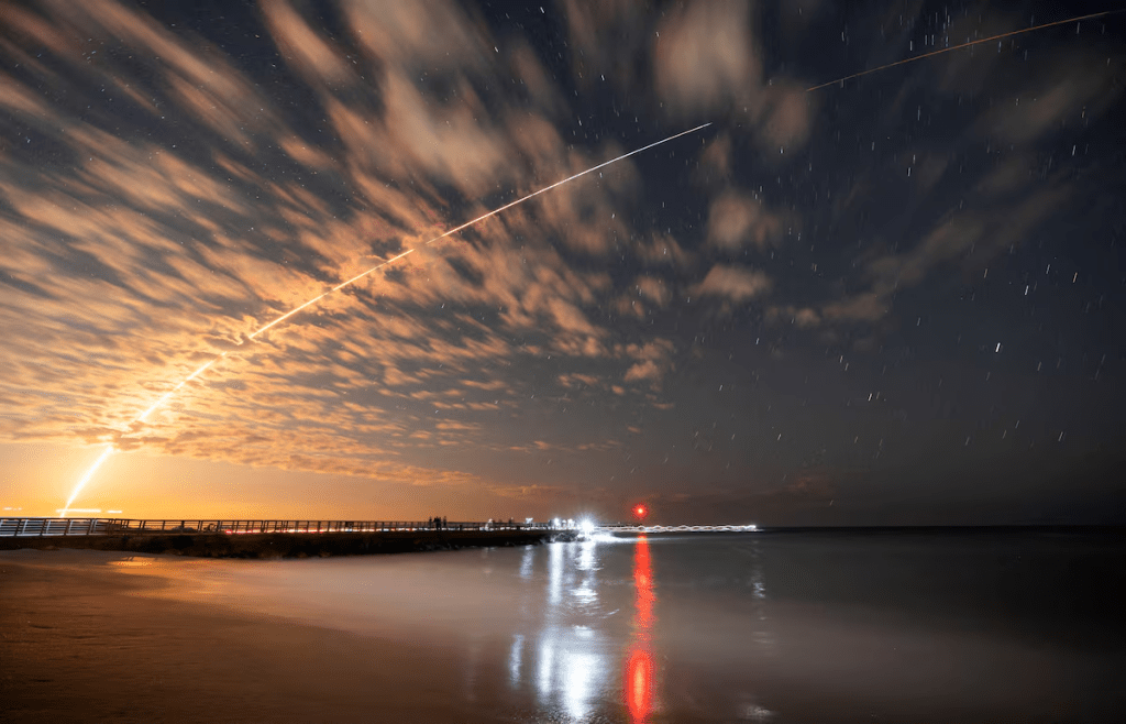 The SpaceX Falcon 9 rocket carrying Starlink satellites is seen over Sebastian Inlet after launching from Cape Canaveral, Florida, U.S., February 26, 2025. REUTERS/Sam Wolfe/File Photo