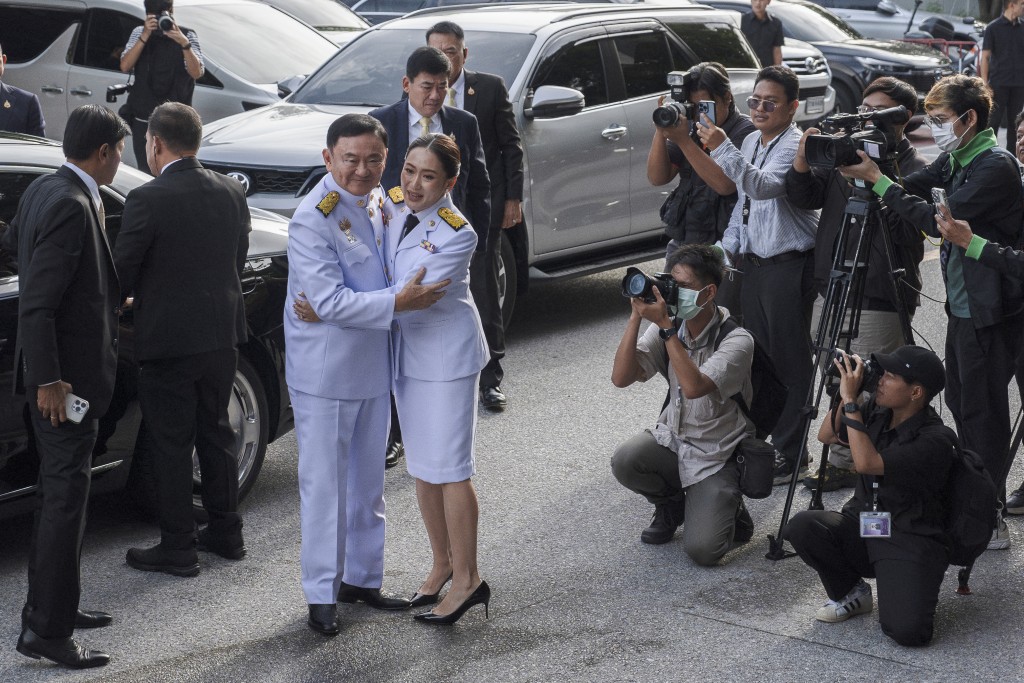 Photo by CHANAKARN LAOSARAKHAM / AFP  Paetongtarn Shinawatra, known by her nickname "Ung Ing”, embraces her father, former prime minister Thaksin Shinawatra, as they arrive for the royal endorsement ceremony officially appointing her as the new prime minister of Thailand, in Bangkok on August 18, 2024.