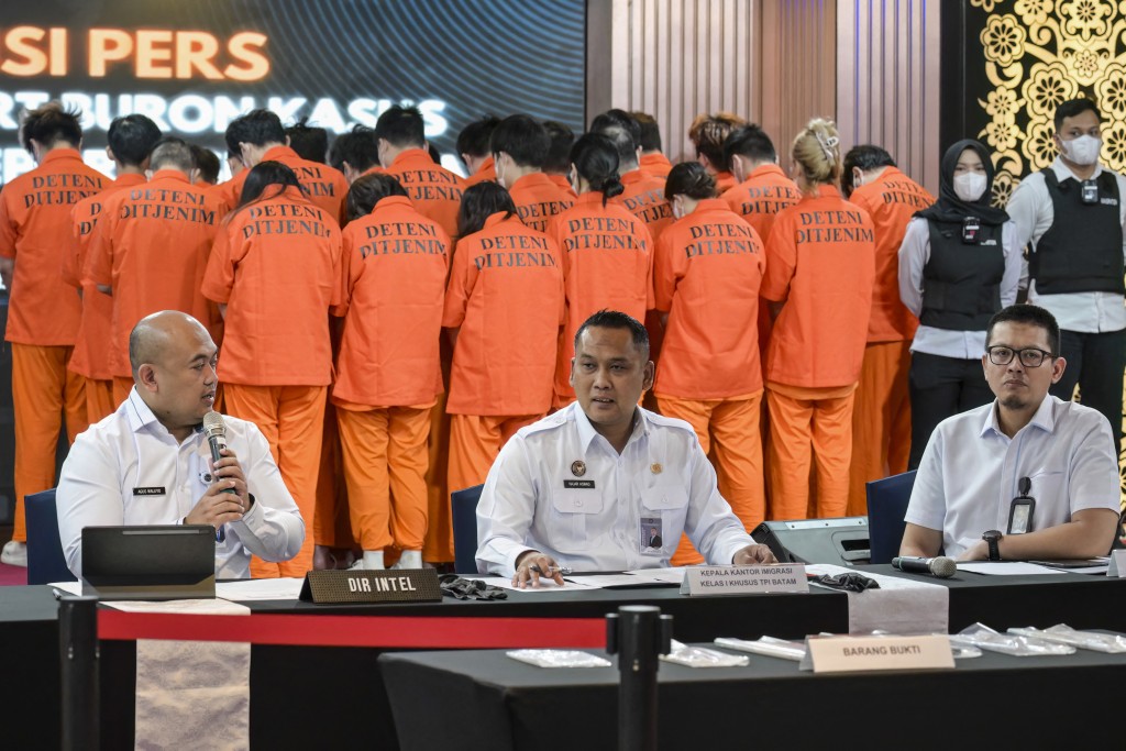  Indonesian Immigration Intelligence Director Police Senior Commissioner Agus Waluyo, Head of Batam Immigration Office Hajar Aswad, and Head of Bekasi Immigration Office Anggi Wicaksono give a press statement at the Immigration office in Jakarta on November 18, 2025  Photo by BAY ISMOYO / AFP