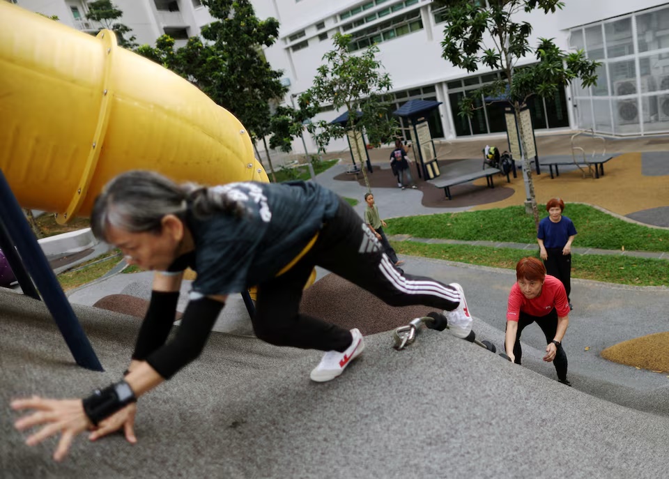 Participants climb during a seniors parkour class in Singapore August 11, 2026. REUTERS/Edgar Su