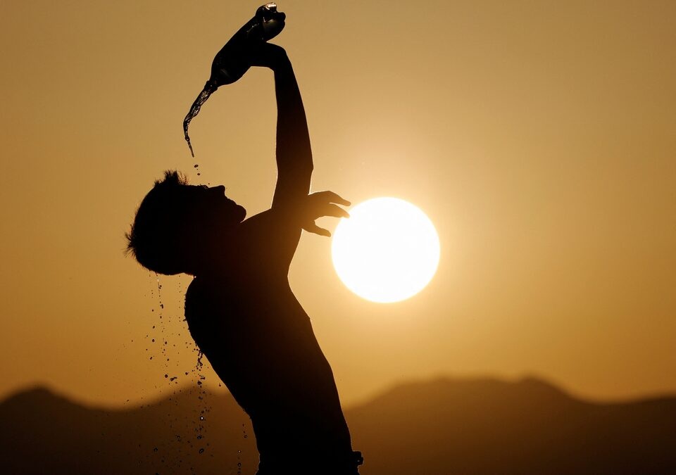 A runner cools down with water in Skopje, North Macedonia July 12, 2023. REUTERS/Ognen Teofilovski 