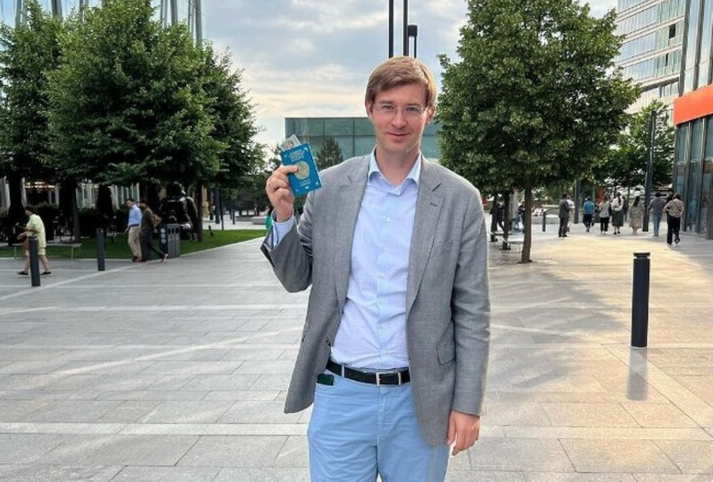 Turlov shows his Kazakh passport.