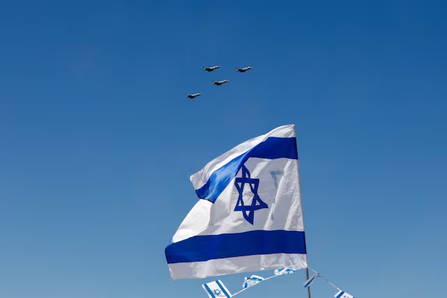 A flypast is seen over an Israeli flag as part of an aerial show organised for Israel's 75th Independence Day celebrations, in Tel Aviv, Israel April 26, 2023. REUTERS/Corinna Kern