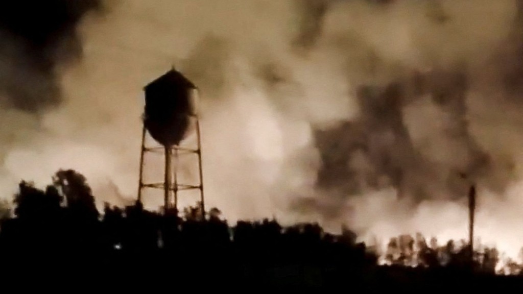 Smoke rises from a fire following a reported strike in Behbahan, Khuzestan Province, Iran. Reuters
