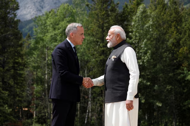 Canadian Prime Minister Mark Carney and India's Prime Minister Narendra Modi shake hands before posing for a photo during the G7 Leaders' Summit in Kananaskis, in Alberta, Canada, June 17, 2025. REUTERS/Amber Bracken 