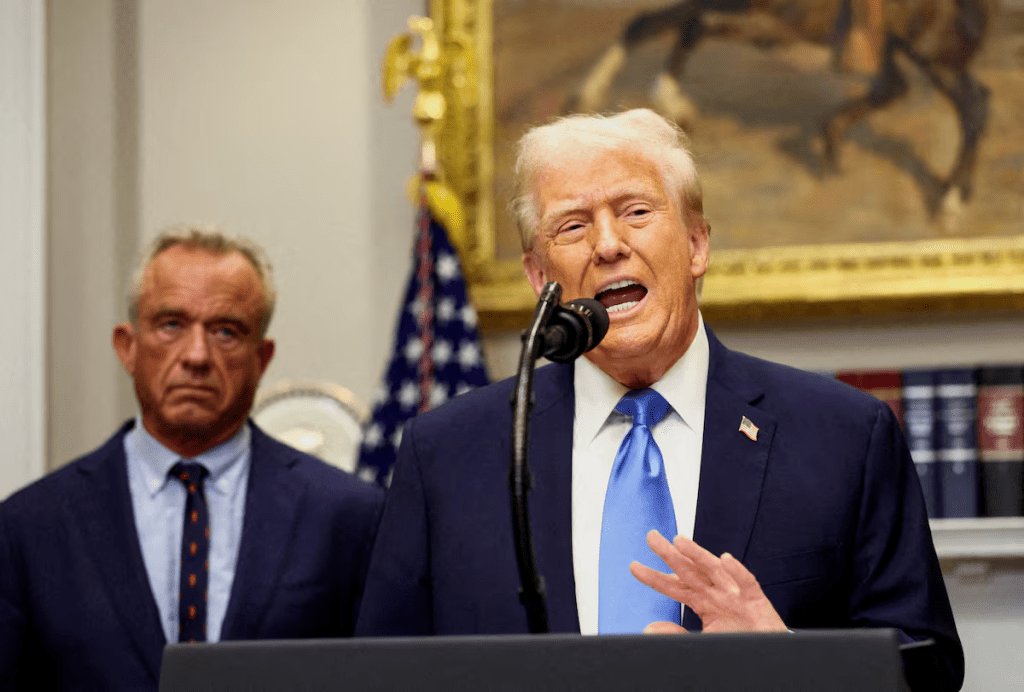 U.S. President Donald Trump, next to U.S. Secretary of Health and Human Services Robert F. Kennedy Jr., makes an announcement linking autism to childhood vaccines and to the use of popular pain medication Tylenol for pregnant women and children, claims which are not backed by decades of science, at the White House, in Washington, D.C., U.S., September 22, 2025. REUTERS/Kevin Lamarque/File Photo