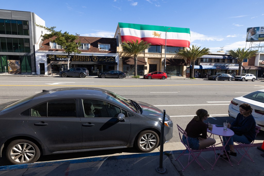 Photo by JONATHAN ALCORN / AFP  People having a beverage outside a cafe in Little Persia, an enclave in West Los Angeles home to the largest Iranian population outside of Iran on January 18, 2026 in Los Angeles, California.