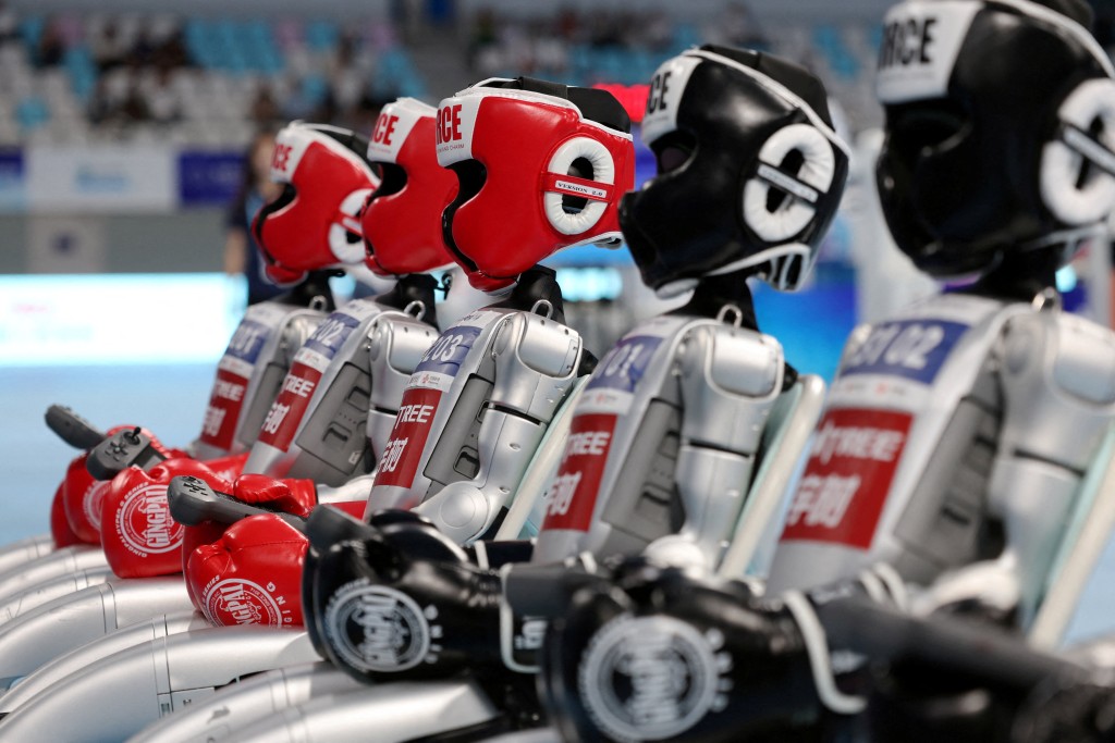 Unitree Robotics humanoid robots sit before a kickboxing match in Beijing, China August 16, 2025./REUTERS/Florence Lo