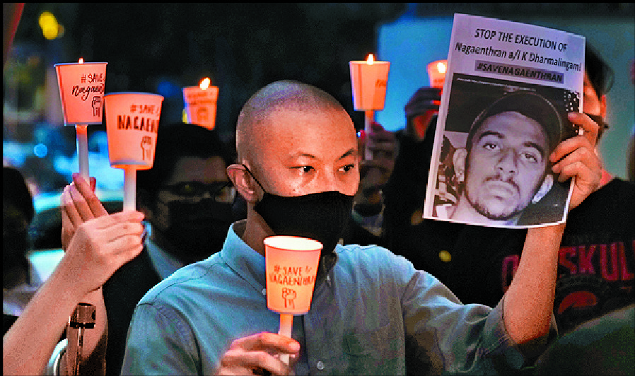 Supporters of Nagaenthran K Dharmalingam hold a vigil in front of the Singaporean embassy in Kuala Lumpur. AP Supporters of Nagaenthran K Dharmalingam hold a vigil in front of the Singaporean embassy in Kuala Lumpur. AP