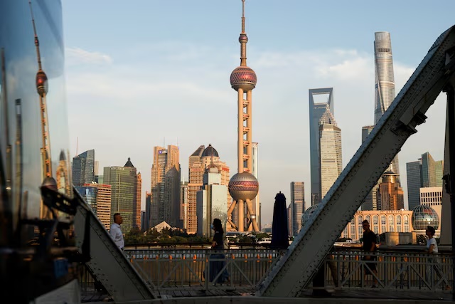 A view of the financial district of Pudong is reflected on a bus passing by, in Shanghai, China September 27, 2024. REUTERS/Tingshu Wang/File Photo