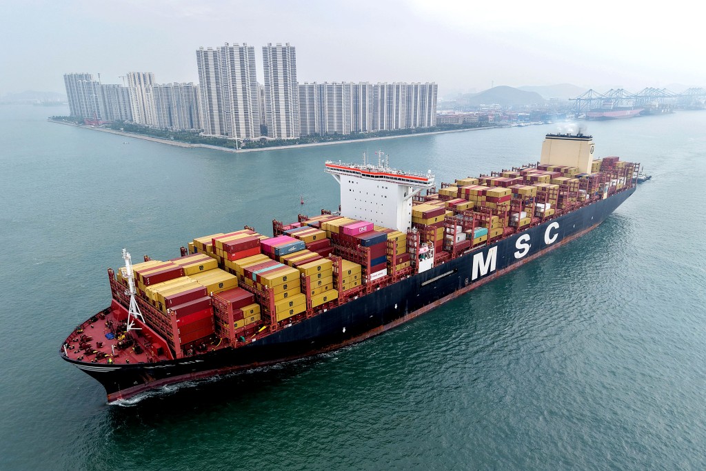 This aerial view shows a container ship moving towards its berth at the container terminal of the port in Qingdao, in China's eastern Shandong province, on September 24, 2025. Photo by - / AFP